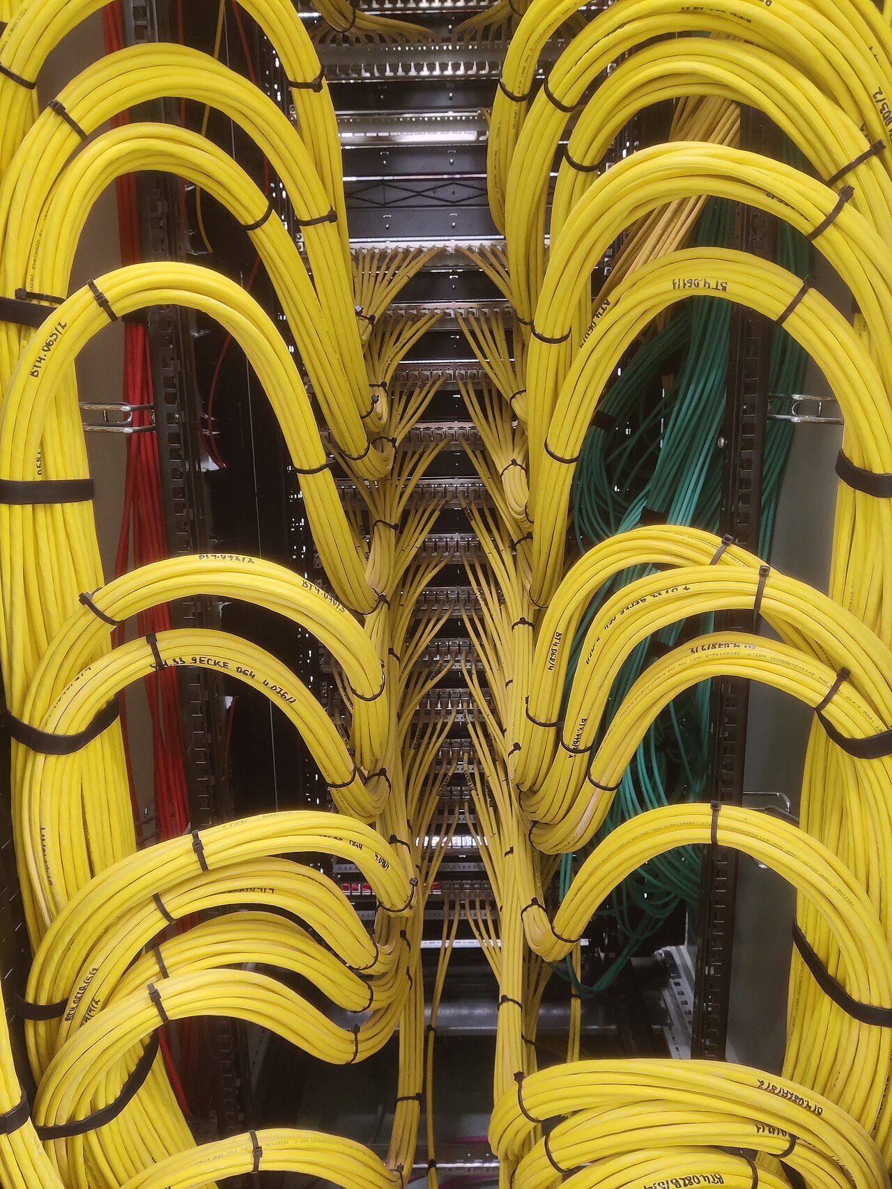 Structured cabling terminated neatly inside a communications cabinet